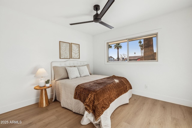 bedroom with ceiling fan and light hardwood / wood-style floors