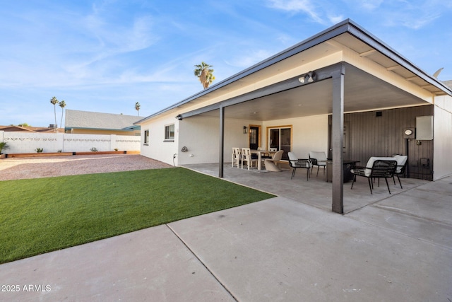 rear view of house with a patio, an outdoor hangout area, and a lawn