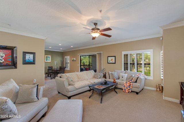 living room featuring ceiling fan, light colored carpet, and crown molding