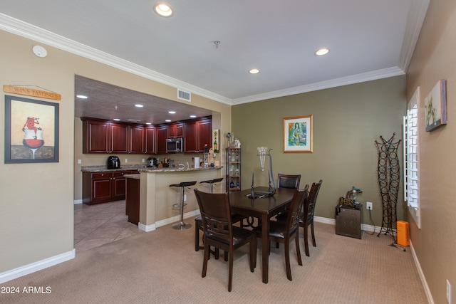 carpeted dining room featuring ornamental molding