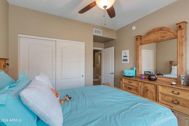 bedroom with ceiling fan and a closet