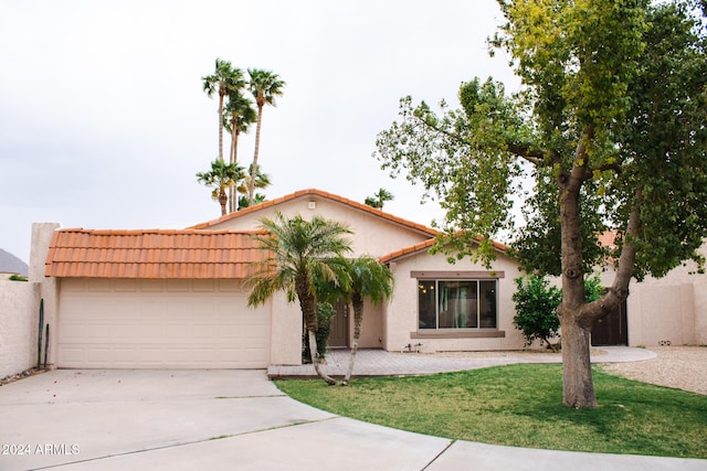 mediterranean / spanish home with a garage