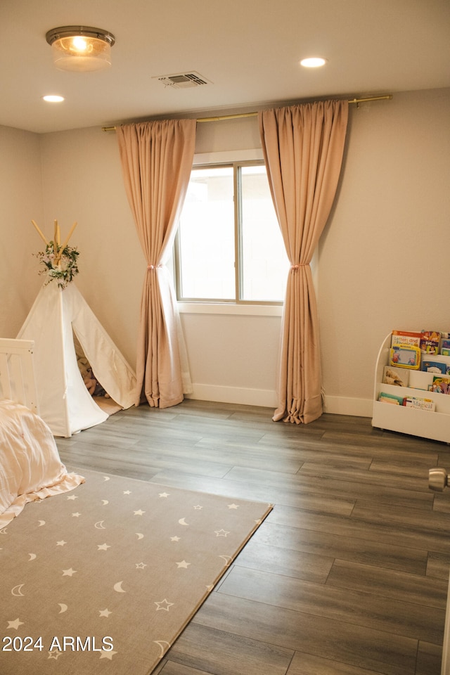 bedroom with hardwood / wood-style floors