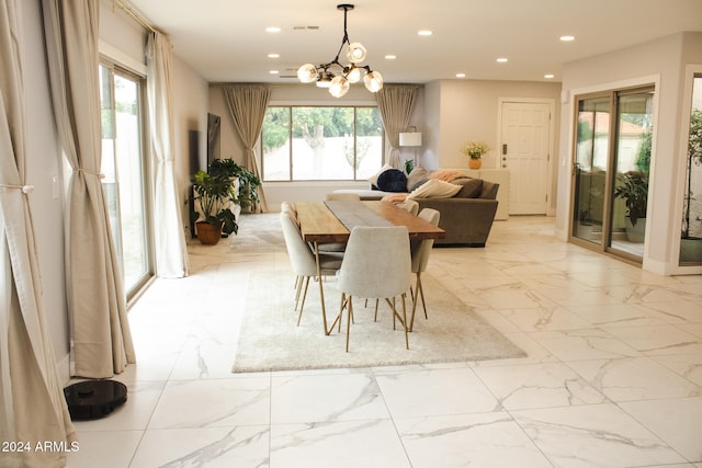 dining area with a healthy amount of sunlight and an inviting chandelier