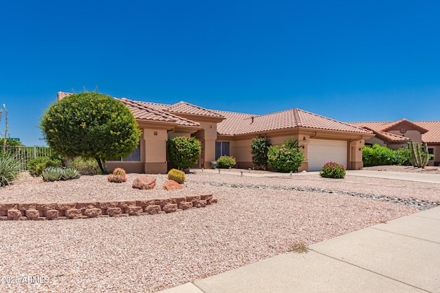 12803 W Amigo Dr, Sun City West, AZ 85375 - view of front facade featuring stucco siding, a tile roof, an attached garage, and concrete driveway