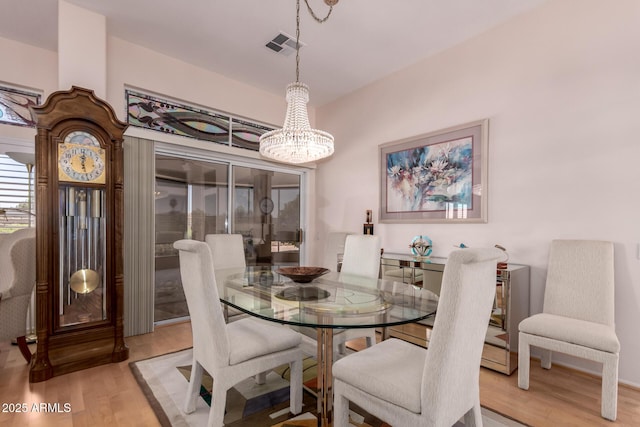 12803 W Amigo Dr, Sun City West, AZ 85375 - dining area featuring wood finished floors and a chandelier