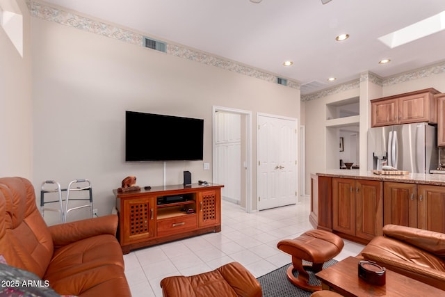 12803 W Amigo Dr, Sun City West, AZ 85375 - living area featuring light tile patterned floors, a skylight, and recessed lighting