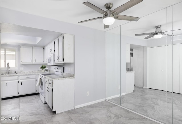 kitchen featuring white cabinets, white appliances, ceiling fan, and sink