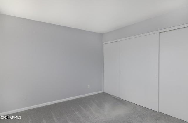 unfurnished bedroom featuring a closet and carpet floors