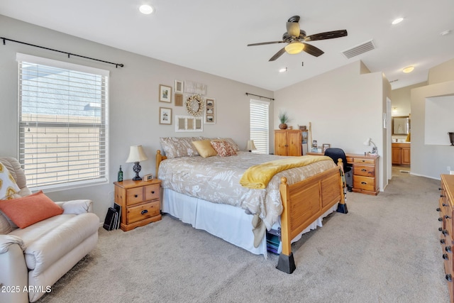 carpeted bedroom featuring ensuite bathroom and ceiling fan