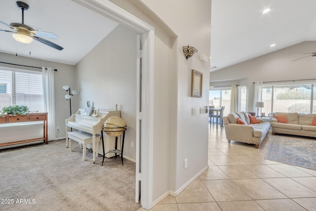 hall featuring vaulted ceiling and light tile patterned floors