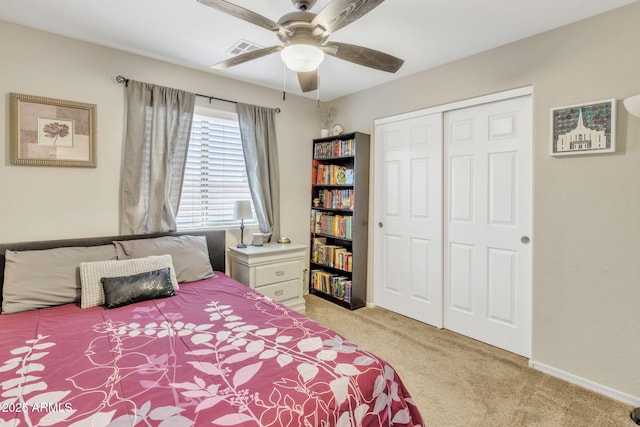 carpeted bedroom with ceiling fan and a closet