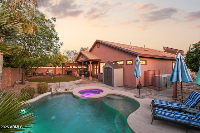 view of pool with a patio area, cooling unit, an in ground hot tub, and a fenced backyard