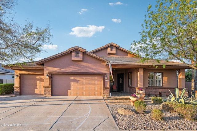 view of front of property with concrete driveway, brick siding, a garage, and stucco siding