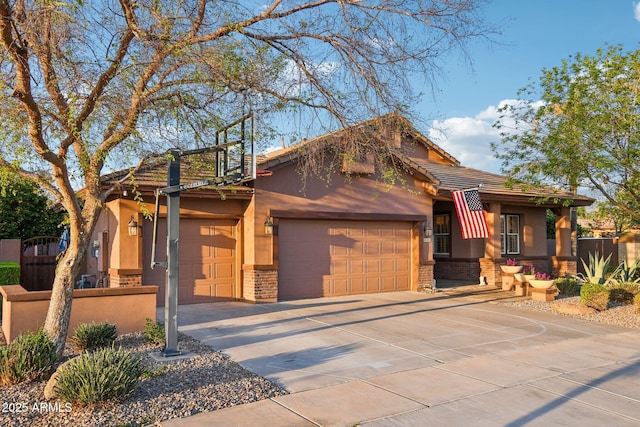 view of front of home featuring brick siding, a tile roof, concrete driveway, stucco siding, and an attached garage