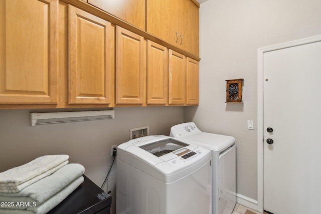 laundry area featuring cabinet space, baseboards, and washer and clothes dryer