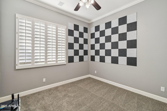 unfurnished room featuring visible vents, baseboards, ceiling fan, crown molding, and carpet flooring