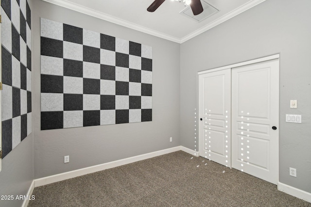 unfurnished bedroom with visible vents, ornamental molding, a closet, carpet flooring, and baseboards