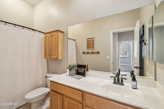 full bathroom featuring vanity and toilet