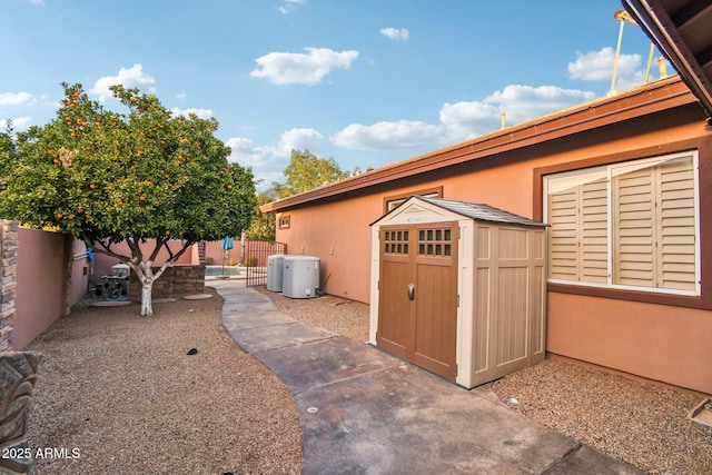 exterior space featuring a storage unit, an outdoor structure, a fenced backyard, and a patio area