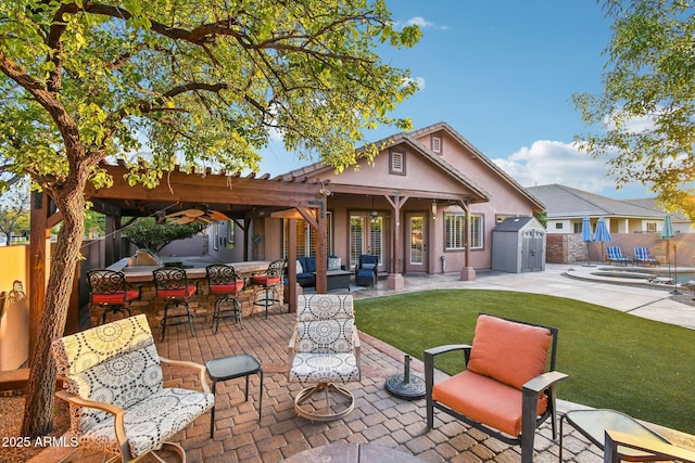 view of patio / terrace with outdoor dry bar, fence private yard, an outdoor hangout area, an outdoor structure, and a storage unit