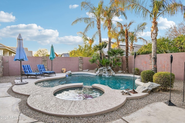 view of pool featuring a fenced in pool, an in ground hot tub, and a fenced backyard