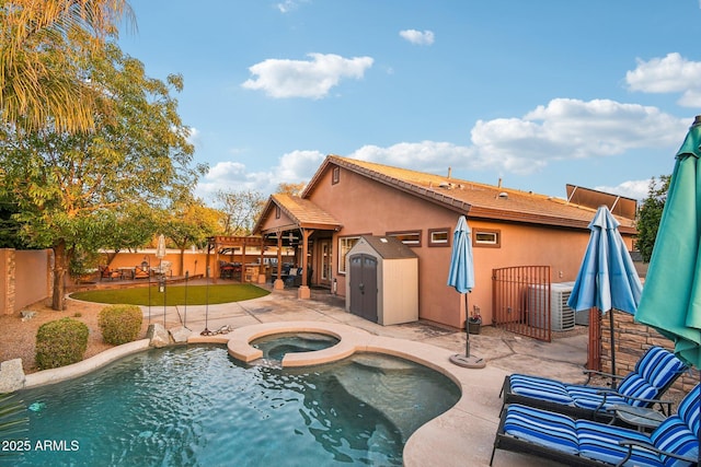 view of swimming pool with central AC, a patio, an in ground hot tub, and a fenced backyard