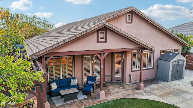 rear view of house with stucco siding and a patio area