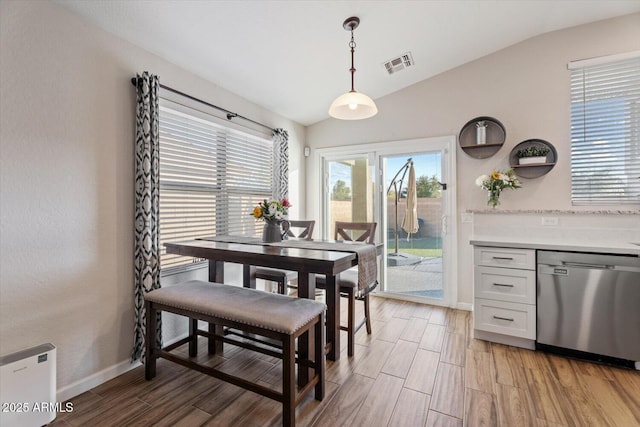 dining room featuring vaulted ceiling