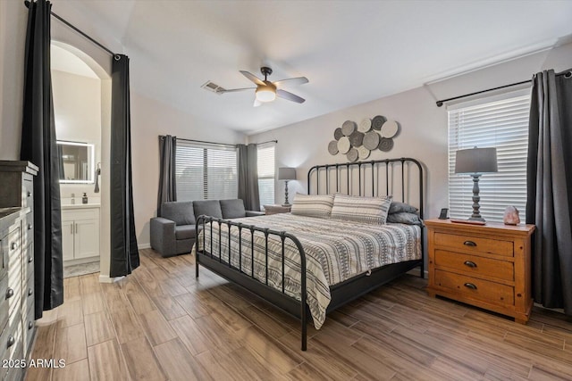 bedroom with connected bathroom, ceiling fan, sink, and lofted ceiling