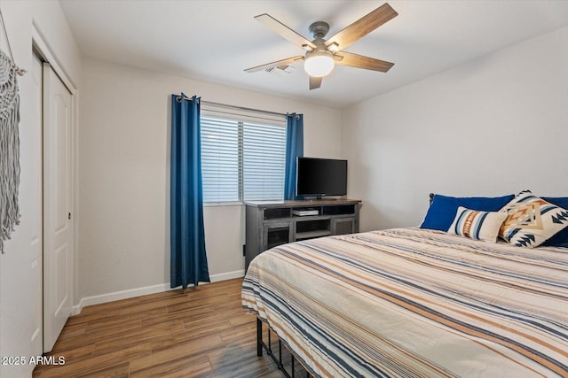 bedroom featuring wood-type flooring, a closet, and ceiling fan