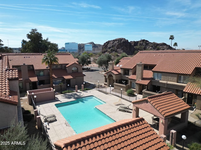 pool with a gazebo, a patio area, fence, and a residential view