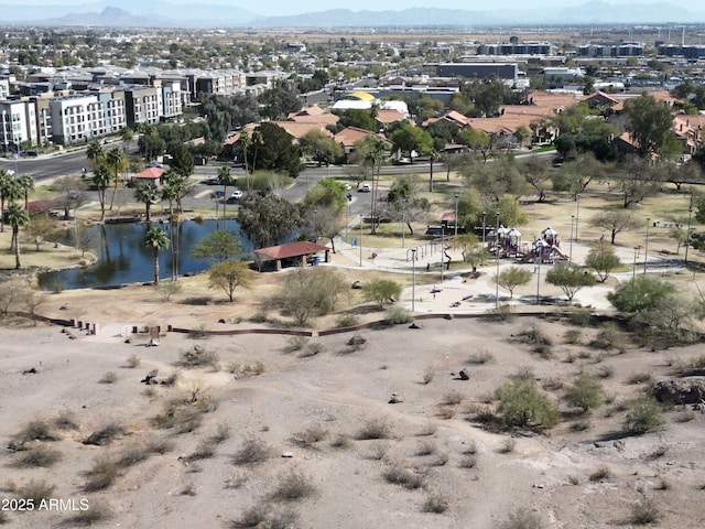 drone / aerial view featuring a water and mountain view