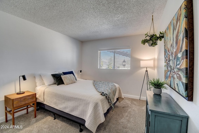 bedroom featuring light colored carpet, a textured ceiling, and baseboards