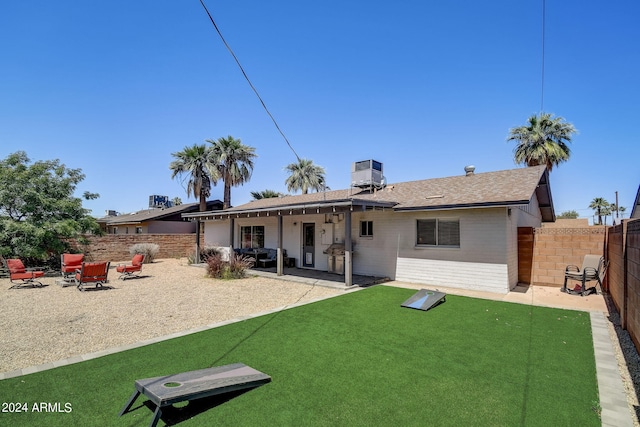 rear view of property with a fenced backyard, central AC unit, brick siding, and a patio