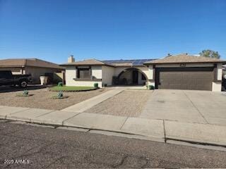 ranch-style house with concrete driveway and an attached garage