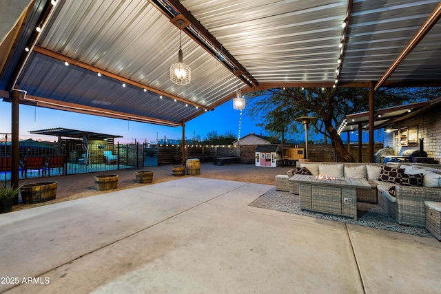 view of patio / terrace with an outdoor living space with a fire pit and a fenced backyard