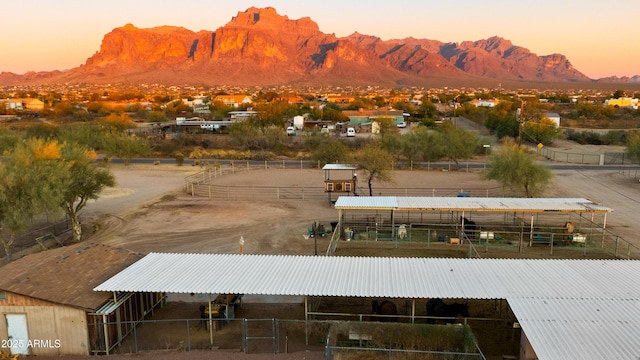 view of community with a mountain view, an exterior structure, and an outdoor structure