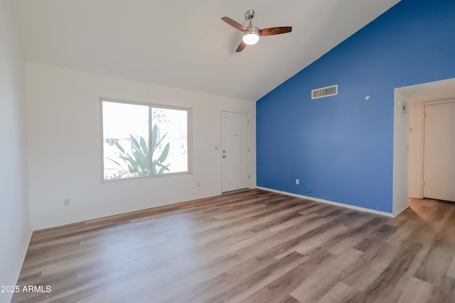 empty room featuring light hardwood / wood-style flooring, high vaulted ceiling, and ceiling fan