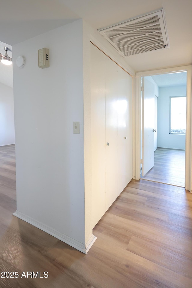 hallway with light hardwood / wood-style flooring