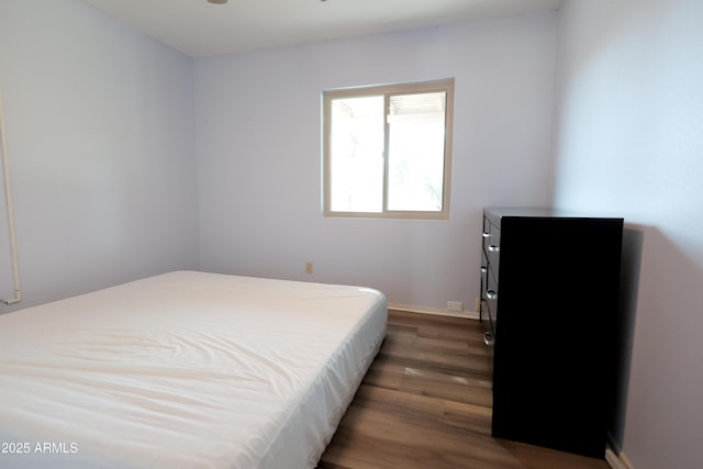 bedroom featuring dark hardwood / wood-style flooring