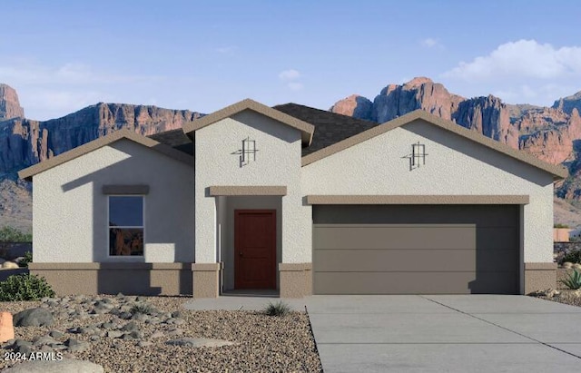 view of front facade with a mountain view and a garage