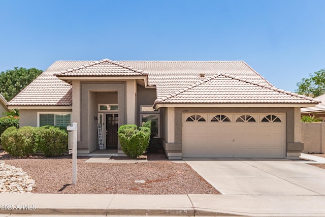 4137 E Stanford Ave, Gilbert, AZ 85234 - view of front of property featuring stucco siding, driveway, a tiled roof, and an attached garage
