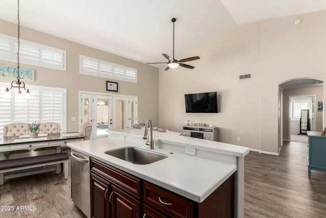 4137 E Stanford Ave, Gilbert, AZ 85234 - kitchen with high vaulted ceiling, a ceiling fan, arched walkways, light countertops, and wood finished floors
