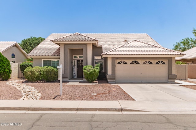 4137 E Stanford Ave, Gilbert, AZ 85234 - view of front of home with stucco siding, concrete driveway, a tiled roof, and a garage