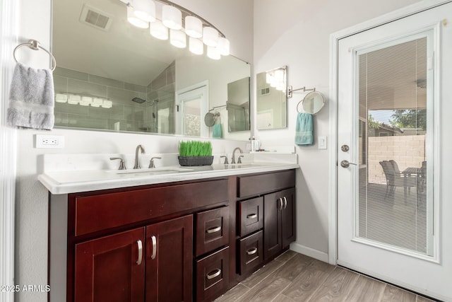4137 E Stanford Ave, Gilbert, AZ 85234 - full bath with double vanity, tiled shower, and wood finished floors