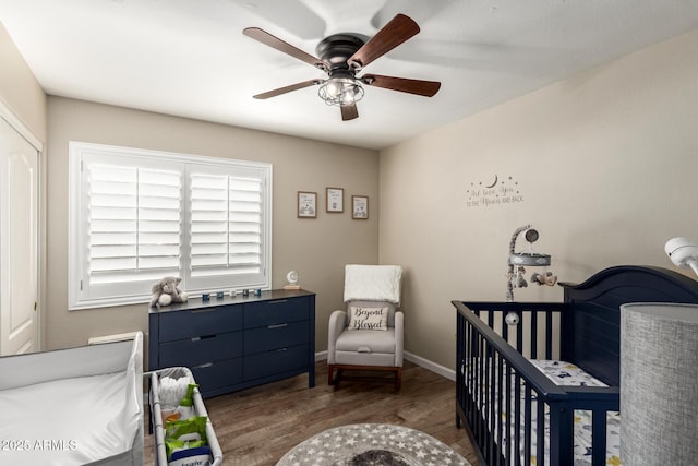 4137 E Stanford Ave, Gilbert, AZ 85234 - bedroom featuring wood finished floors, a crib, and a ceiling fan