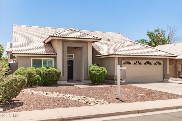4137 E Stanford Ave, Gilbert, AZ 85234 - view of front facade featuring stucco siding, a garage, a tile roof, and driveway