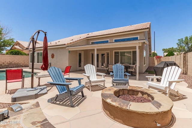 4137 E Stanford Ave, Gilbert, AZ 85234 - fenced backyard with french doors, an outdoor fire pit, a patio, and grilling area