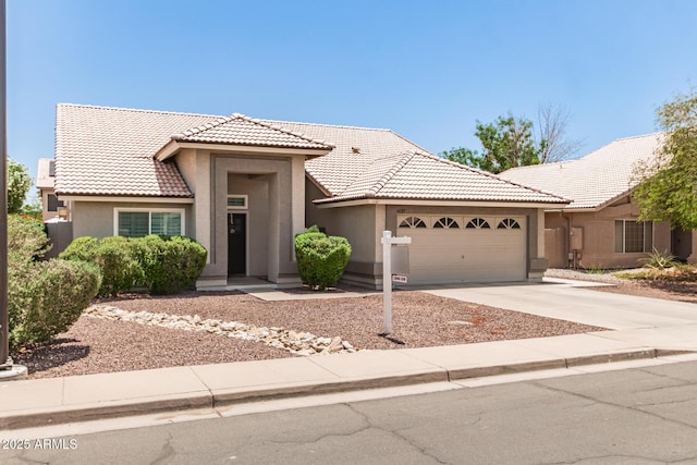4137 E Stanford Ave, Gilbert, AZ 85234 - view of front of house featuring stucco siding, a garage, a tile roof, and concrete driveway